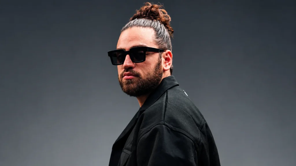 Ali Gatie wearing sunglasses and a black jacket
