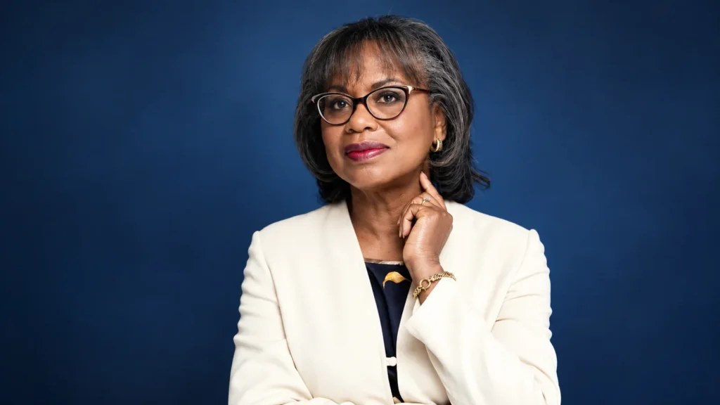 Kathy Ambush wearing an ivory blazer and glasses in a professional portrait
