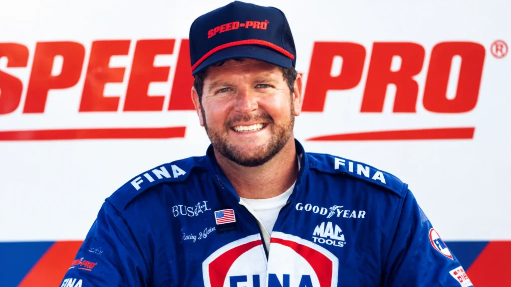 Randy LaJoie smiling in a blue FINA racing suit