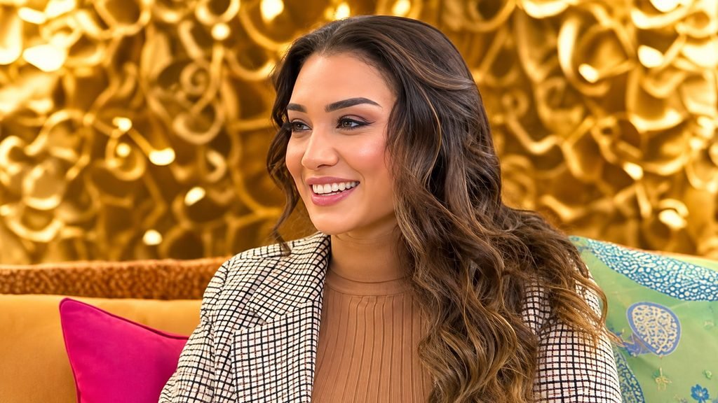 Zahirah Marty smiling during an interview in a stylish indoor setting